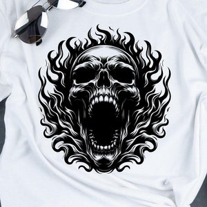 May include: White t-shirt with a black and white graphic of a skull with flames. The skull is screaming with its mouth open.