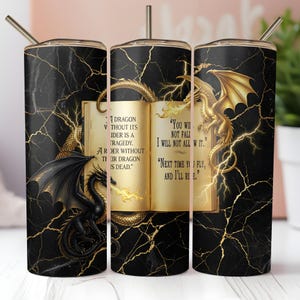 May include: A black and gold tumbler featuring a dragon theme. The design includes a black marble background with gold lightning bolt accents. The tumbler has a book with dragon quotes and illustrations of dragons.