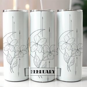 May include: Three white stainless steel tumblers with black floral designs and the word "FEBRUARY" on the middle tumbler.