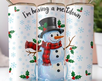 May include: A white tumbler with a snowman design. The snowman wears a black top hat, red scarf, and has a carrot nose. The tumbler has the text "I'm having a meltdown" and is decorated with snowflakes and holly.