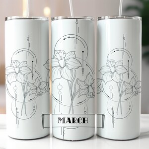 May include: White stainless steel tumbler featuring a black and white graphic of a daffodil flower with geometric shapes and the word "March" on a banner.