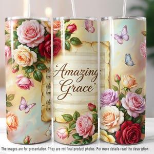 May include: A floral tumbler featuring a design with roses in shades of pink, red, and cream, along with butterflies. The words "Amazing Grace" are displayed on a parchment-style background with musical notes. The tumbler has a straw.