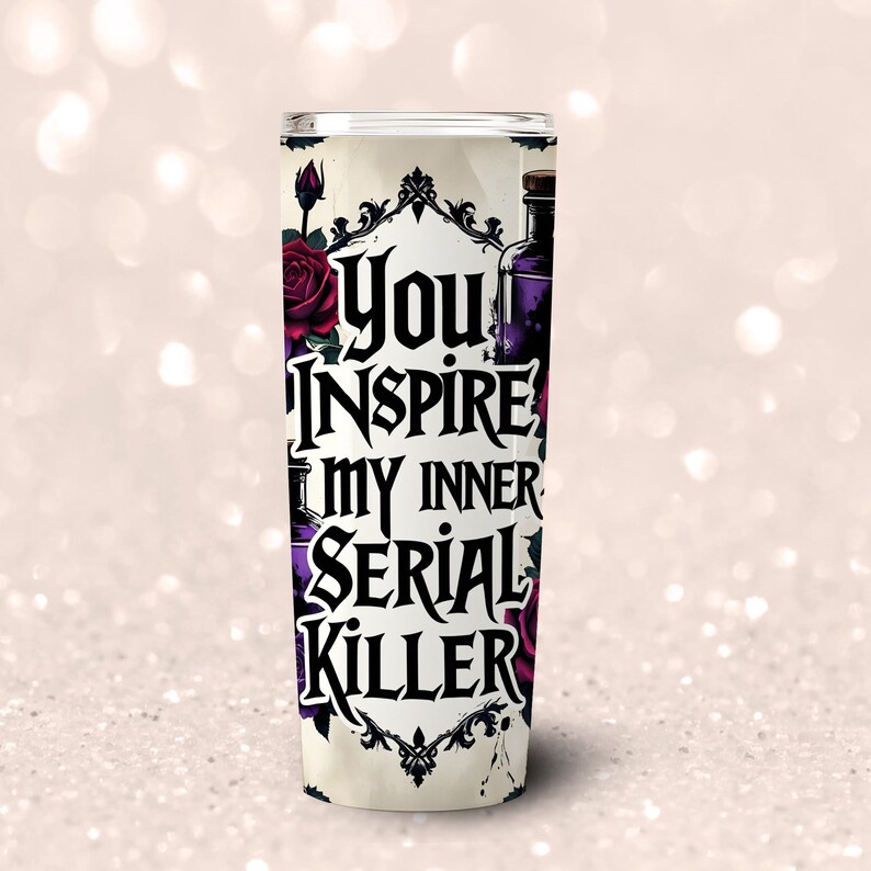 May include: A tall, cylindrical tumbler with the text "You Inspire My Inner Serial Killer" in black gothic lettering. The design includes dark red roses, purple potion bottles, and ornate black frames against a cream background.