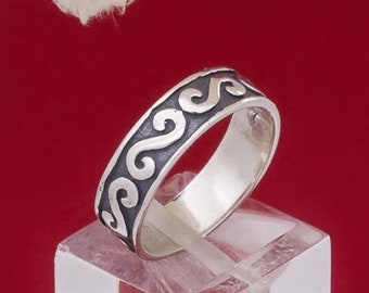 May include: A silver band ring with a black wave design. The ring is on a white display stand.