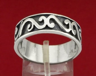May include: A silver ring with a decorative wave design. The ring is wide and has a polished finish.