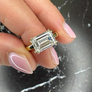 East to West Emerald Cut 3.1 carat Total IGI Certified D Color VVS2 Clarity Lab Grown Diamond Solitaire Hidden Halo Engagement Ring 14k Gold