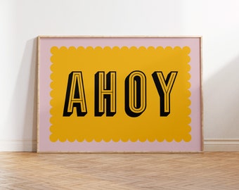 May include: A pink framed print with a yellow scalloped border and the word "AHOY" in black outlined letters.