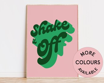 May include: A pink poster with green text that reads "Shake it off" in a retro font style. The poster has a white border and is framed.