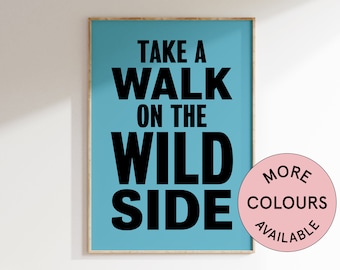 May include: A blue poster with white wood frame featuring the text "Take a walk on the wild side" in black bold letters. A pink circle with the text "More Colours Available" is in the bottom right corner.