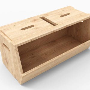 May include: A wooden storage box with two lids and a cutout handle. The box is made of light wood and has a natural finish.