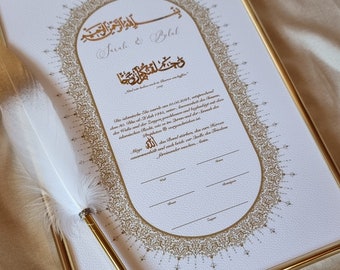 May include: A framed Islamic wedding certificate with gold calligraphy and intricate designs. The certificate is signed by the couple, Sarah and Bolal, and includes the date of the wedding, 10.06.2019.