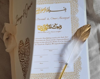 May include: A white and gold Islamic wedding certificate with ornate calligraphy and a gold pen with a white feather. The text reads "Bismillah ir-Rahman ir-Rahim" and "Und wir haben euch in Baren erschaffen."
