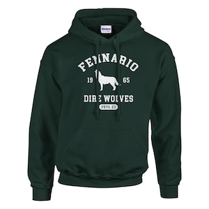 May include: A dark green hooded sweatshirt with a white graphic print. The graphic features a wolf silhouette, the text "Fennario 19 65 Dire Wolves Phys. Ed.", and a distressed vintage look.