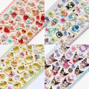 Puede incluir: Cuatro hojas de pegatinas en relieve de colores con varios personajes y diseños de dibujos animados. Las pegatinas incluyen imágenes de gatos, fresas, lazos y otros elementos lindos en tonos de rojo, rosa, amarillo y morado.