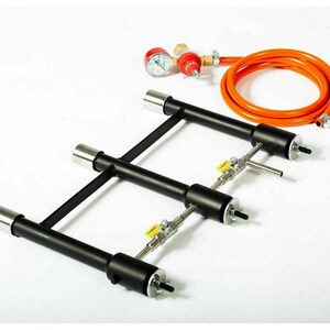 May include: A black metal propane burner with three adjustable flames. The burner has a hose and regulator with a pressure gauge.