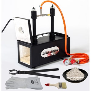 May include: A black metal forge with a white ceramic lining and a red and orange gas hose. The forge is labelled "DEVIL-FORGE". The image also shows a pair of tongs, a pair of welding gloves, a paintbrush, and a small plate of refractory mortar.