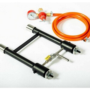 May include: A black metal propane burner with two adjustable arms and a hose connected to a regulator with a pressure gauge. The burner is designed for outdoor cooking and grilling.