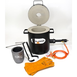 May include: A black metal melting furnace with a grey ceramic crucible, a crucible tong, a pair of leather welding gloves, a gas regulator, and a 10kg crucible. The furnace has a silver label that reads "Devil-Forge".