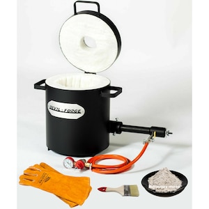 May include: A black metal furnace with a white ceramic lining and a removable lid. The furnace is labelled "Devil-Forge" and includes a hose, a pressure gauge, a pair of orange leather welding gloves, a paintbrush, and a small bowl of refractory mortar.