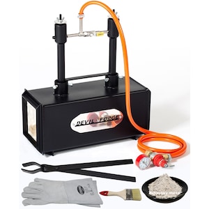 May include: A black metal gas forge with a red and white logo that says "Devil Forge". The forge comes with a set of accessories including tongs, gloves, a paintbrush, and a bag of refractory mortar.