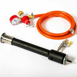 May include: A black and silver torch with a long handle and a red pressure gauge. The torch is connected to an orange hose with a brass valve.