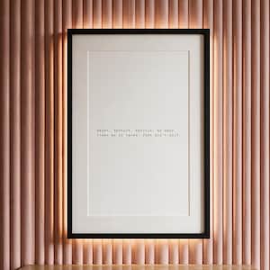 Black and white discipline typography print, apartment wall decor above a warm travertine console, an encouraging gift for the persistent.