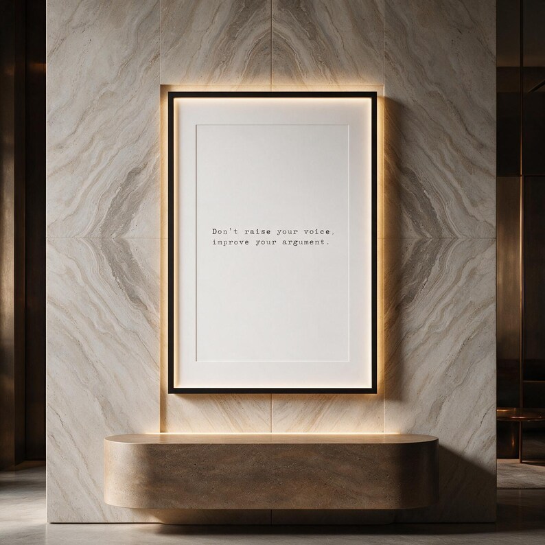 Framed black and white typographic debate print in a backlit pale travertine niche.