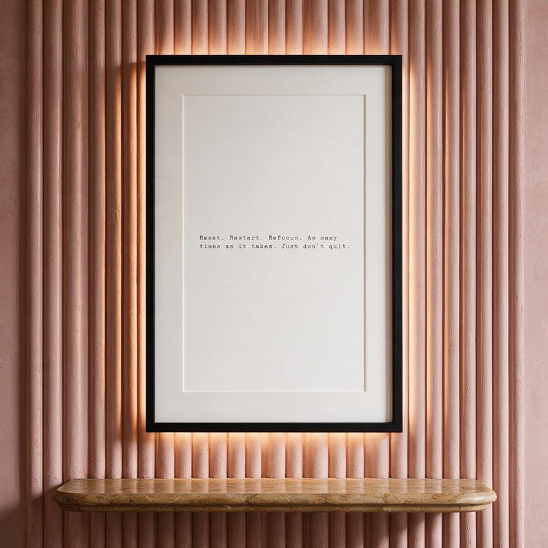 Black and white discipline typography print, apartment wall decor above a warm travertine console, an encouraging gift for the persistent.