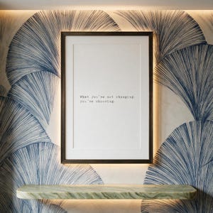 Framed discipline typography print in a dark bronze frame on a navy hand-drawn fan mural wall, study decor above a pale green banded marble shelf, a considered gift for a graduate or a founder.