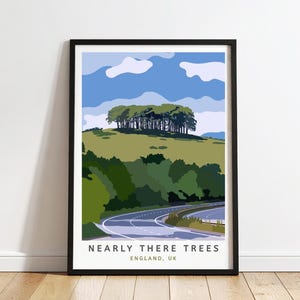 May include: A framed art print depicting a scenic landscape with a road, green hills, and a group of trees under a blue sky. The text "NEARLY THERE TREES ENGLAND, UK" is at the bottom of the print.
