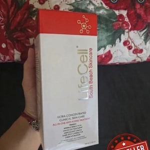 May include: A white and red box of LifeCell South Beach Skincare, an all-in-one anti-aging treatment. The box features the text "ULTRA-CONCENTRATED CLINICAL SKIN CARE" and "BEST SELLER" in a red badge. The background is a floral pattern.