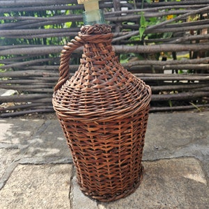 Antique Demijon Old wicker wine bottle. Glass wine bottle wrapped in woven willow branches. 5L