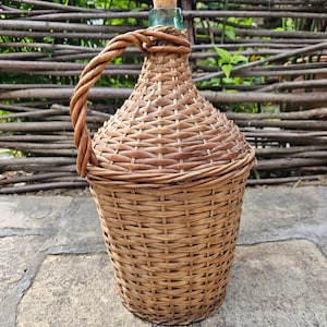 Antique Demijon Old wicker wine bottle. Glass wine bottle wrapped in woven willow branches. 8L