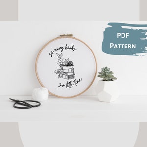 May include: A black and white embroidery pattern featuring a stack of books with flowers and the text "So many books, so little time".