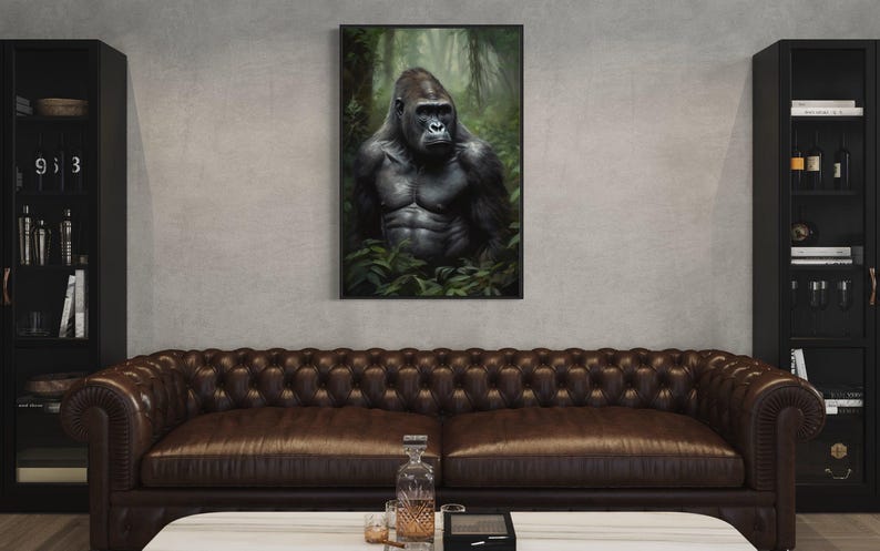 a large, dark brown leather couch in a living room setting. Above the couch, there is a framed painting of a gorilla in a lush, green forest. The room also includes a bookshelf and a coffee table with various items on it.