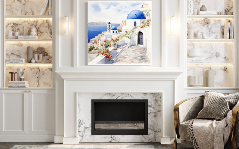 a living room with a fireplace, a bookshelf, and a framed picture of a scenic view of a Greek island with a blue dome and white buildings.