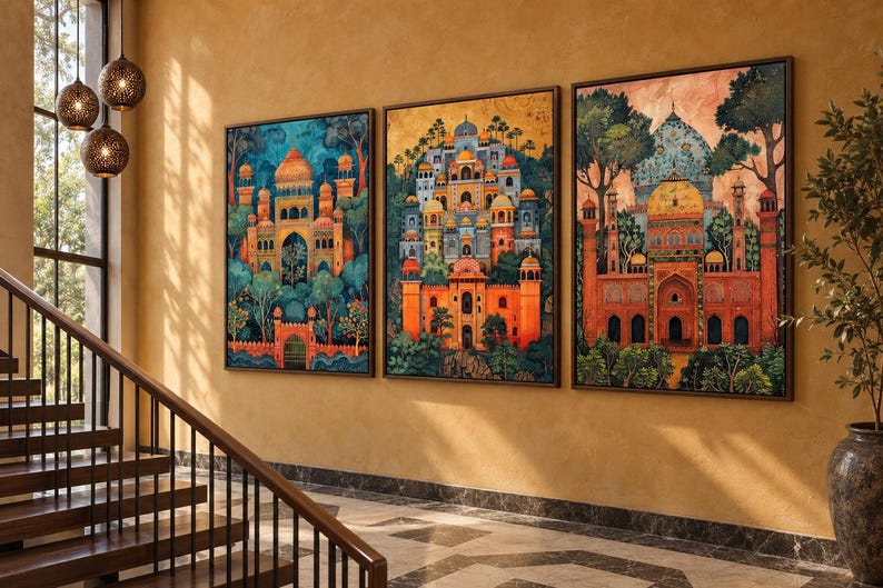 May include: Three rectangular framed wall art prints featuring detailed illustrations of ornate palaces with domes, arches, and towers, set amidst lush green trees. The artwork displays vibrant colour palettes of orange, blue, and gold tones.