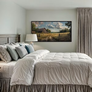 a serene bedroom with a large bed, a wooden headboard, and a painting of a rural landscape hanging on the wall. The room has a neutral color scheme with gray curtains and a white comforter on the bed.