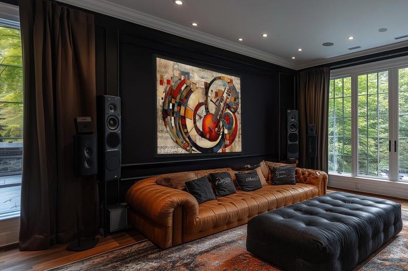 a modern living room with a large abstract painting on the wall, a brown leather sofa, a black ottoman, and a large window overlooking trees.