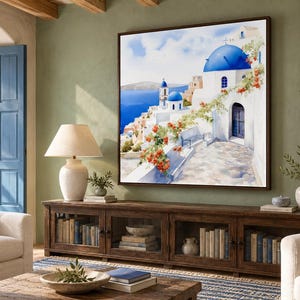 May include: A square wall art print featuring a Mediterranean coastal scene with white buildings, bright blue domes, and orange flowers. The painting depicts a stone pathway leading toward the sea under a clear sky, framed in a dark brown border.