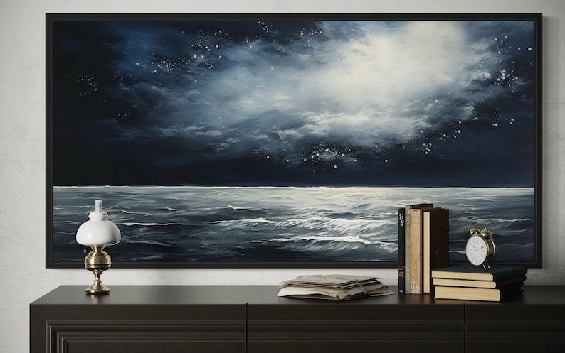 a large painting of a night sky with a dark blue background and white stars, hanging on a wall above a wooden dresser. On the dresser, there is a lamp, a stack of books, and a clock.