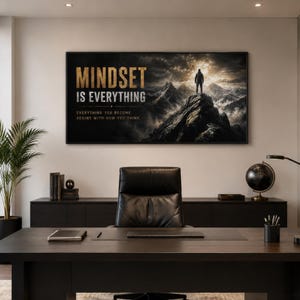 May include: A rectangular wall art print featuring a mountain landscape with a person standing on a peak. The text reads "MINDSET IS EVERYTHING" in large gold letters, followed by "EVERYTHING YOU BECOME BEGINS WITH HOW YOU THINK" in smaller white text.