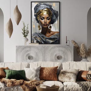 a modern living room with a white sofa adorned with colorful throw pillows. Above the sofa, there is a framed painting of a woman with a headdress, adding an artistic touch to the room. The room also includes a white archway, a potted plant, and a vase, contributing to the overall aesthetic.