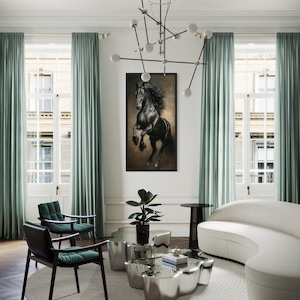 a modern living room with a large black horse painting on the wall, a white sofa, a round coffee table, and a large chandelier overhead.