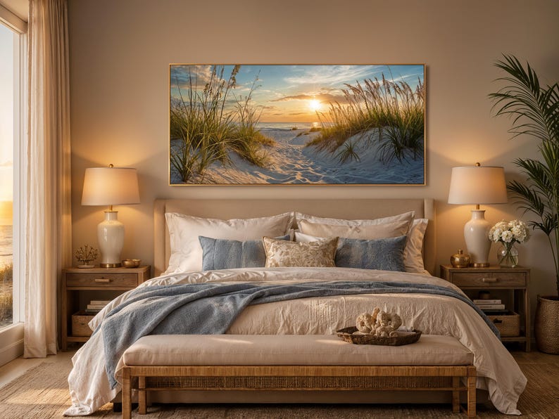 May include: A rectangular landscape wall art print featuring a sunset over a sandy beach with tall dune grasses. The scene displays a golden sun low on the horizon, casting light over white sand dunes and coastal vegetation under a blue sky.