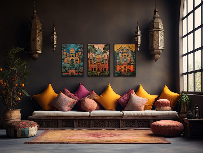 a cozy living room with a long sofa adorned with colorful pillows, a rug, and a large window that allows natural light to fill the space. The walls are decorated with three vibrant paintings, and the room is further embellished with decorative lamps and potted plants.