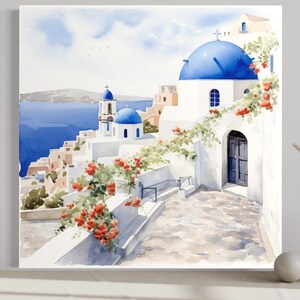 The image is a watercolor painting depicting a picturesque view of a Greek island with white buildings, blue domes, and a winding path leading to the water.