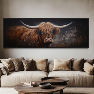 a large painting of a horned animal, likely a yak or a bull, displayed on the wall above a beige sofa in a living room setting.