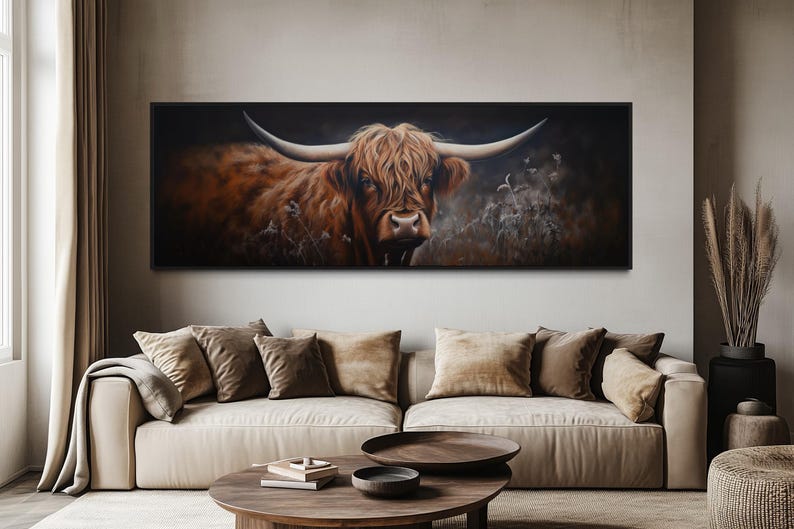 a large painting of a horned animal, likely a yak or a bull, displayed on the wall above a beige sofa in a living room setting.