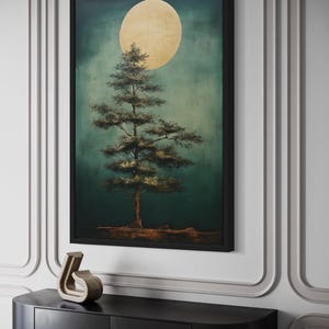 a large framed painting of a tree with a large yellow moon in the background, hanging on a wall above a black shelf.